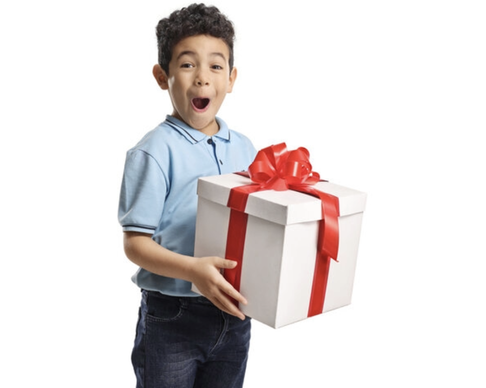 Child excitedly holding a wrapped birthday gift